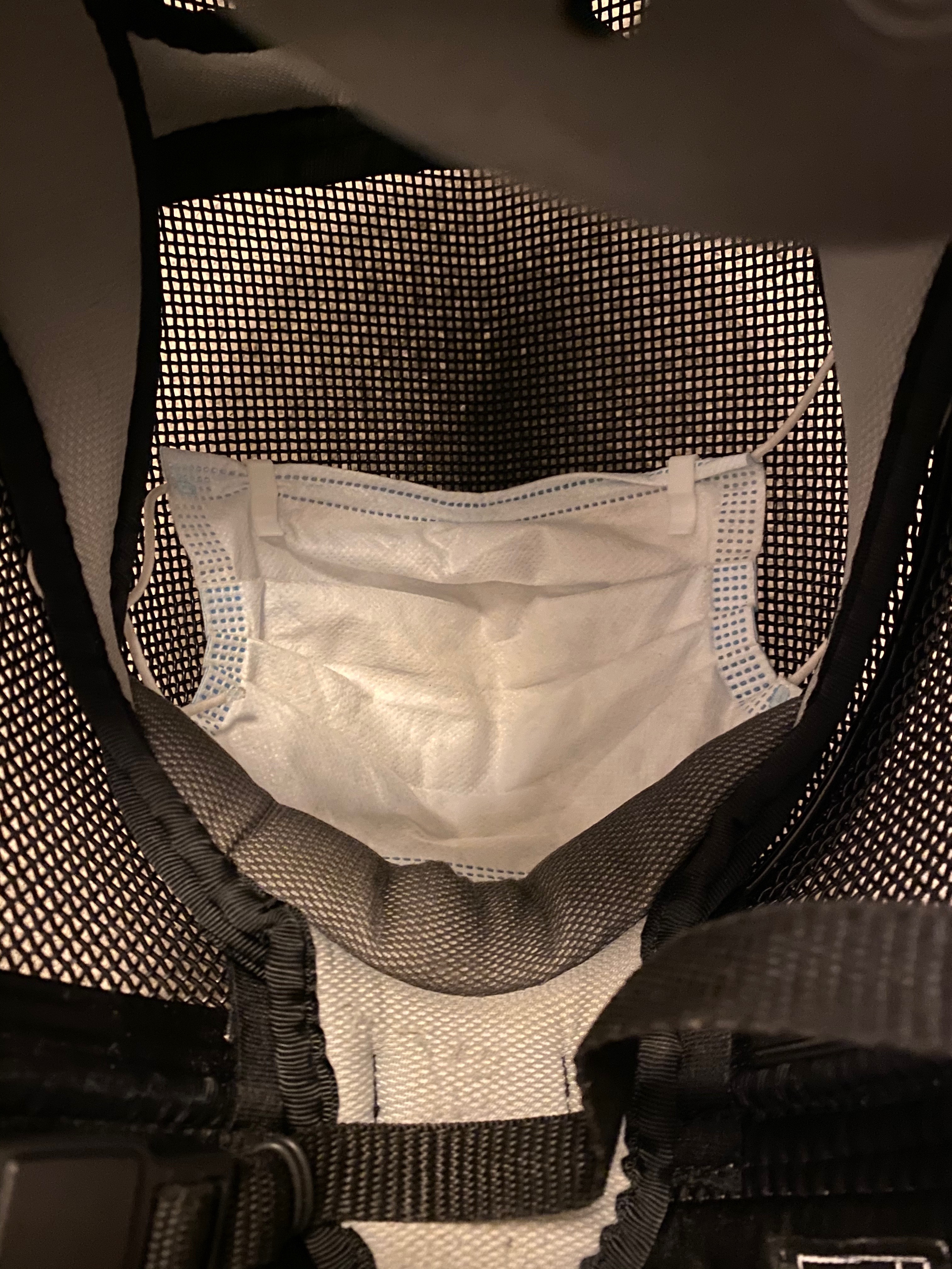 Clips fitted into a fencing mask with a face mask held in place